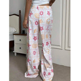 Person wearing pajama pants with starfish and shell pattern in a bedroom setting